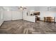 Spacious living room featuring wood-style herringbone floors and open layout to kitchen at 610 Roberta Alecia Ave, North Las Vegas, NV 89031