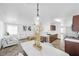 Open living space with modern decor, herringbone floors, and stainless steel appliances, bathed in natural light at 610 Roberta Alecia Ave, North Las Vegas, NV 89031