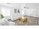 Open-concept living room featuring wood floors, white furniture, and natural light at 610 Roberta Alecia Ave, North Las Vegas, NV 89031