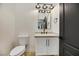 Elegant powder room with white vanity, modern fixtures, and mirror at 62 Incline Village Ct, Henderson, NV 89074