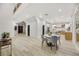 Open concept dining area with light hardwood floors and modern light fixtures at 62 Incline Village Ct, Henderson, NV 89074