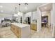 Modern kitchen featuring a large island, custom cabinetry, and stainless steel appliances at 62 Incline Village Ct, Henderson, NV 89074