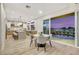 Kitchen with dining area and view of pool and sunset at 62 Incline Village Ct, Henderson, NV 89074