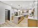 Modern kitchen with light wood cabinets, quartz countertops, and stainless steel appliances at 62 Incline Village Ct, Henderson, NV 89074