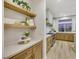 Modern kitchen with light wood cabinets, open shelving, and a large window at 62 Incline Village Ct, Henderson, NV 89074