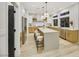 Modern kitchen with island, stainless steel appliances, and light wood cabinets at 62 Incline Village Ct, Henderson, NV 89074