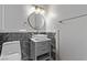 Modern bathroom with floating vanity and a round mirror at 6412 Miragrande Dr, Las Vegas, NV 89108