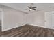 Well-lit bedroom with wood-look flooring and ceiling fan at 6412 Miragrande Dr, Las Vegas, NV 89108