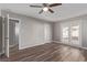 Bright bedroom featuring wood-look floors and double doors to a patio at 6412 Miragrande Dr, Las Vegas, NV 89108