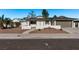 Ranch-style home with landscaped yard, attached garage, and walkway at 6412 Miragrande Dr, Las Vegas, NV 89108