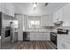 Updated kitchen featuring white shaker cabinets and quartz countertops at 6412 Miragrande Dr, Las Vegas, NV 89108