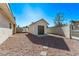 Private backyard with storage shed and gravel landscaping at 6412 Miragrande Dr, Las Vegas, NV 89108