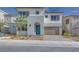 Two-story home with modern design, attached garage, and teal front door at 6828 Pacific Robin St, North Las Vegas, NV 89084