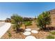 A landscaped playground with turf mounds and lush greenery, set within a residential community at 6828 Pacific Robin St, North Las Vegas, NV 89084