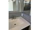 Bathroom with gray tile, modern vanity, and mirror at 707 Arrowhead Trl, Henderson, NV 89002