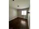 Simple bedroom with dark hardwood floors and neutral walls at 707 Arrowhead Trl, Henderson, NV 89002