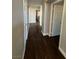 Long hallway with dark hardwood floors at 707 Arrowhead Trl, Henderson, NV 89002