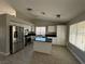 Kitchen with white cabinets, granite counters, and island at 707 Arrowhead Trl, Henderson, NV 89002