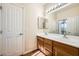 Bathroom with double vanity and wood cabinets at 7131 Celadine St, Las Vegas, NV 89131