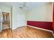 Bedroom with wood floors, ceiling fan and access to hallway at 7131 Celadine St, Las Vegas, NV 89131