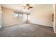 Spacious carpeted bedroom with ceiling fan and large window at 7131 Celadine St, Las Vegas, NV 89131