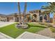 Single-story home with a three-car garage, artificial turf, and desert landscaping at 7131 Celadine St, Las Vegas, NV 89131