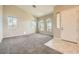 Living room with neutral carpeting, a tile entryway, and large windows at 7131 Celadine St, Las Vegas, NV 89131