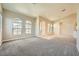 Open concept living room with neutral carpeting and high ceilings at 7131 Celadine St, Las Vegas, NV 89131