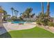 Inviting pool and spa surrounded by lush landscaping and a grassy lawn at 7131 Celadine St, Las Vegas, NV 89131