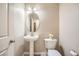 Small powder room with pedestal sink, toilet and oval mirror at 7131 Celadine St, Las Vegas, NV 89131