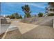 Landscaped backyard with gravel, concrete patio and block wall at 7214 Paradise Bay Dr, Las Vegas, NV 89119