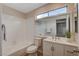 Well-lit bathroom with single vanity, bathtub, and toilet at 7214 Paradise Bay Dr, Las Vegas, NV 89119