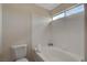 Bright bathroom featuring a bathtub, white tile, and a window for natural light at 7214 Paradise Bay Dr, Las Vegas, NV 89119