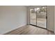 Bedroom with wood-look flooring and sliding glass door to the backyard at 7214 Paradise Bay Dr, Las Vegas, NV 89119