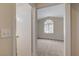 View of the bedroom through a doorway, highlighting the arched window at 7214 Paradise Bay Dr, Las Vegas, NV 89119