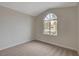 Bedroom with plush carpeting and a unique arched window providing lots of natural light at 7214 Paradise Bay Dr, Las Vegas, NV 89119