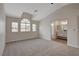 Spacious carpeted bedroom with arched windows and ensuite bathroom at 7214 Paradise Bay Dr, Las Vegas, NV 89119