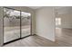 Bedroom with wood-look flooring and sliding glass door to backyard at 7214 Paradise Bay Dr, Las Vegas, NV 89119