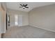 Spacious carpeted bedroom featuring a modern ceiling fan and neutral color palette at 7214 Paradise Bay Dr, Las Vegas, NV 89119