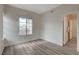 Sunlit bedroom with wood-look floors and bright windows at 7214 Paradise Bay Dr, Las Vegas, NV 89119