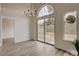 Dining room features wood-look flooring, modern chandelier, and sliding door at 7214 Paradise Bay Dr, Las Vegas, NV 89119