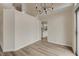 Dining room features wood-look flooring, modern chandelier, and natural lighting at 7214 Paradise Bay Dr, Las Vegas, NV 89119