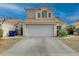 Two-story house with a white garage door and desert landscaping at 7214 Paradise Bay Dr, Las Vegas, NV 89119