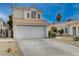 Exterior view of a well-maintained home featuring a two-car garage and neatly landscaped yard at 7214 Paradise Bay Dr, Las Vegas, NV 89119