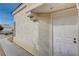 White front door with sidelights, and stone accents at 7214 Paradise Bay Dr, Las Vegas, NV 89119