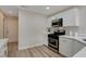 Kitchen features stainless steel appliances, quartz counters, and modern cabinetry at 7214 Paradise Bay Dr, Las Vegas, NV 89119