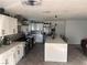 Spacious kitchen featuring white cabinets, a large island, and stainless steel appliances at 7221 Tempest Pl, Las Vegas, NV 89145