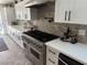 Modern kitchen with a large stainless steel range and white cabinets at 7221 Tempest Pl, Las Vegas, NV 89145