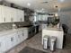 Modern kitchen with white cabinets, a large island, and stainless steel appliances at 7221 Tempest Pl, Las Vegas, NV 89145