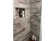 Shower with modern gray wood-look tiles at 7221 Tempest Pl, Las Vegas, NV 89145